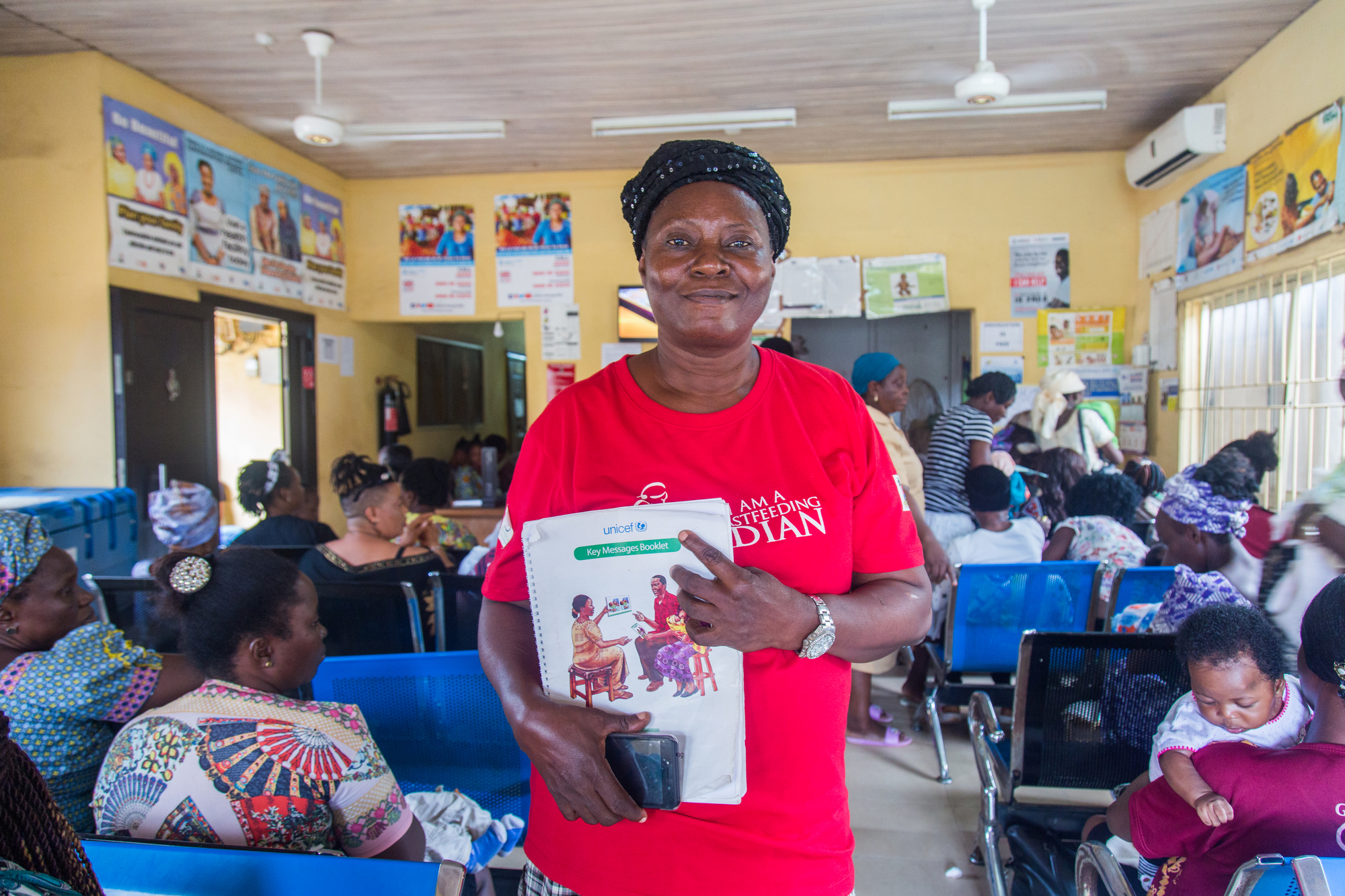 Mrs. Kudirat Akintan (65), breastfeeding guardian, poses at Ojodu PHC  in Lagos, Nigeria