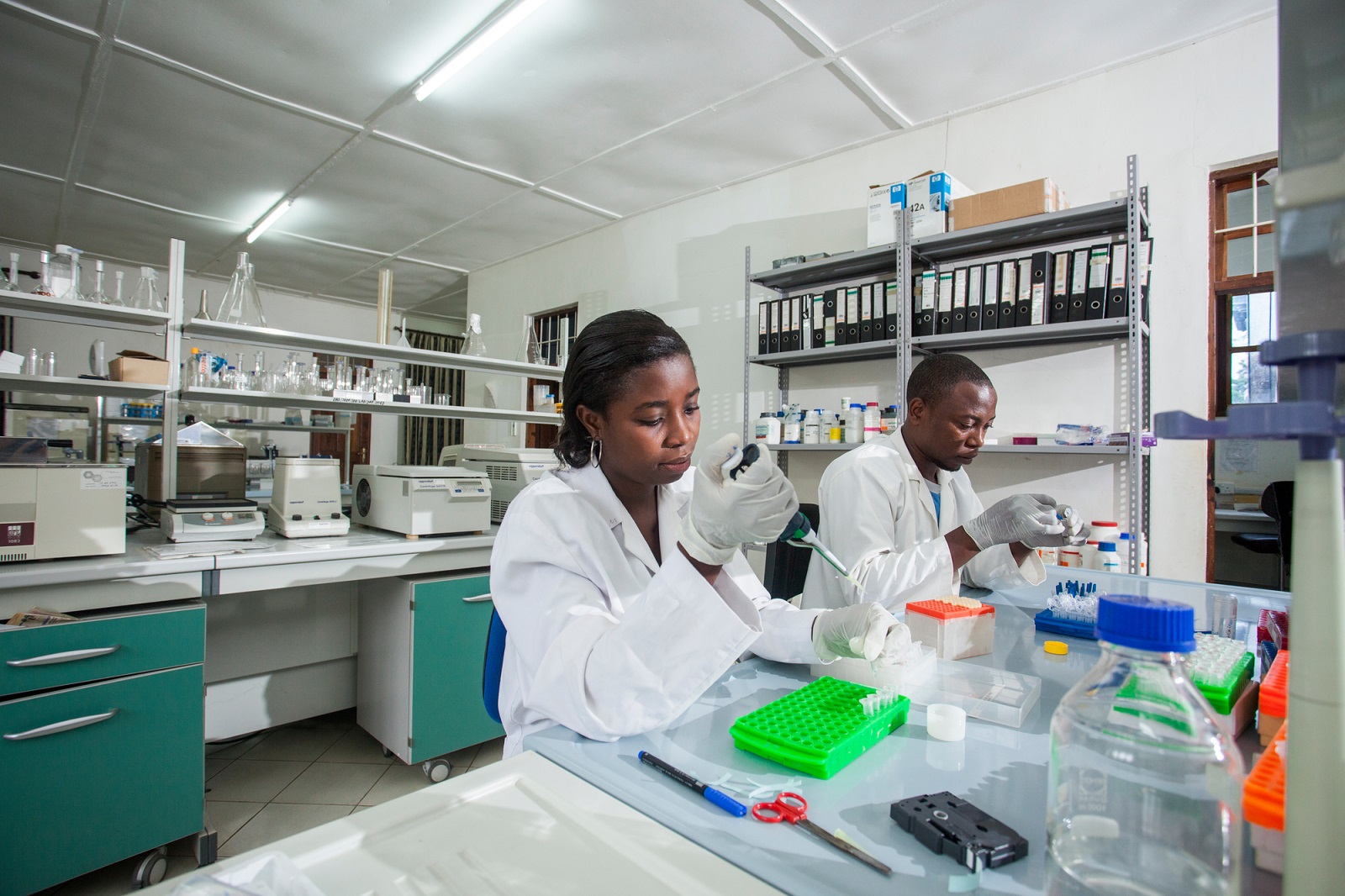 Lab technicians Deogratius Roman and Violet Francis get mosquito samples ready for DNA extraction in Ikafara Health Institute laboratory in Ifakara, Tanzania.