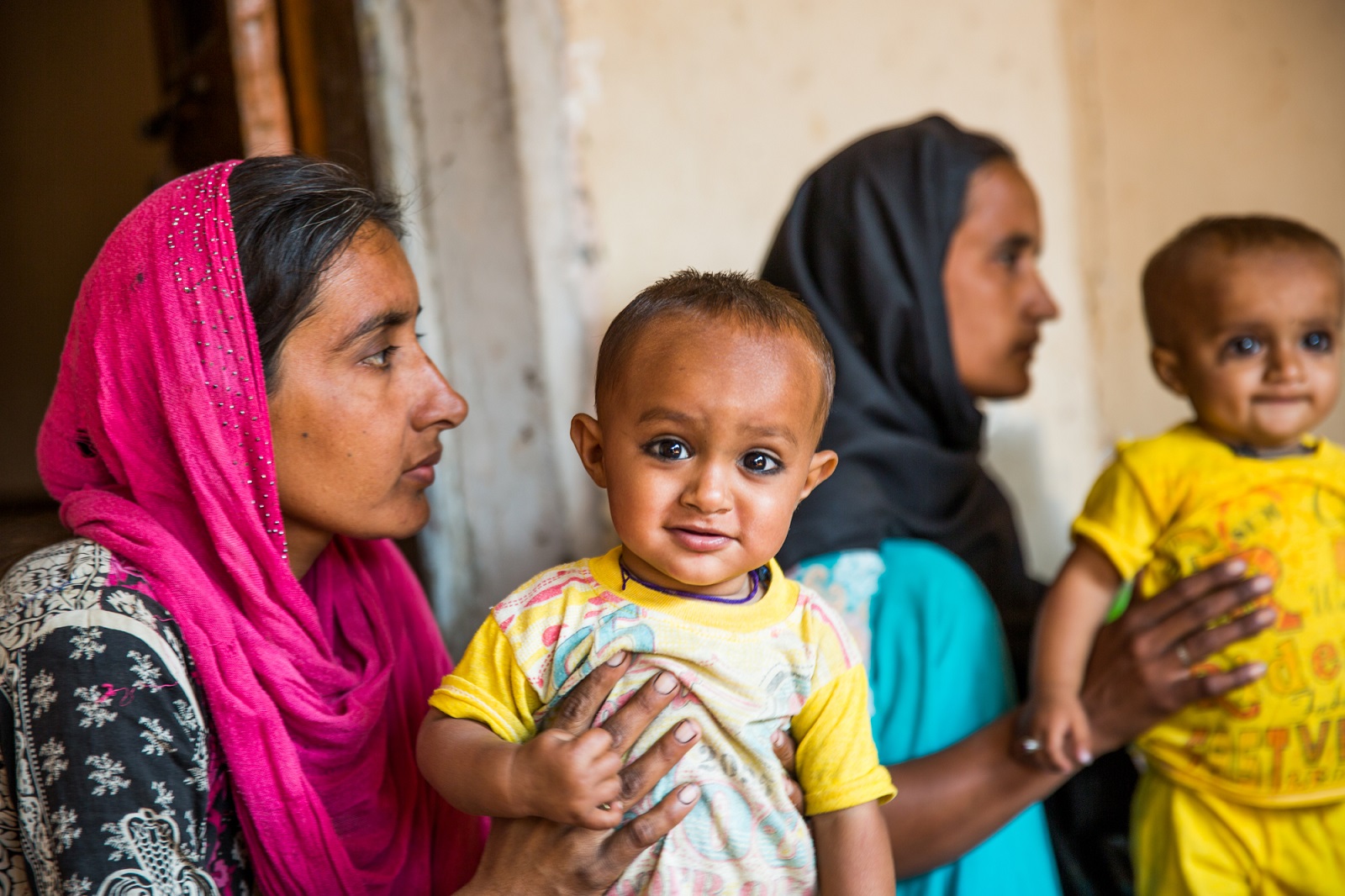  Iram (right) with her son Tanveer (8 month old) and Shehzadi with her son Shehzan (9 month old) attending Nutrition session in Porath village, Matiari district, Sindh province, Pakistan.