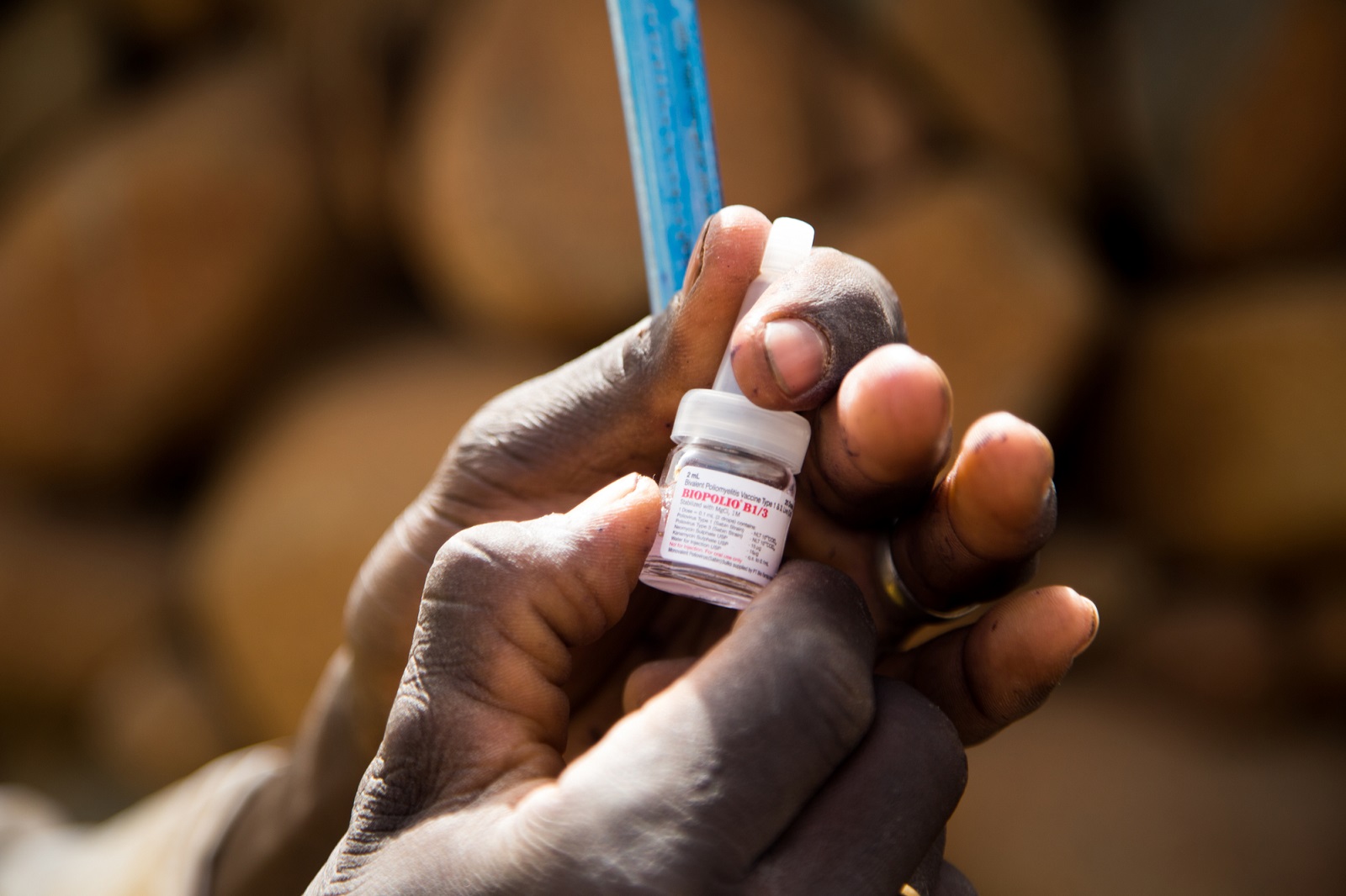 A certified vaccinator prepares a polio vaccine during a door to door vaccine campaign in Adia, Cameroon.