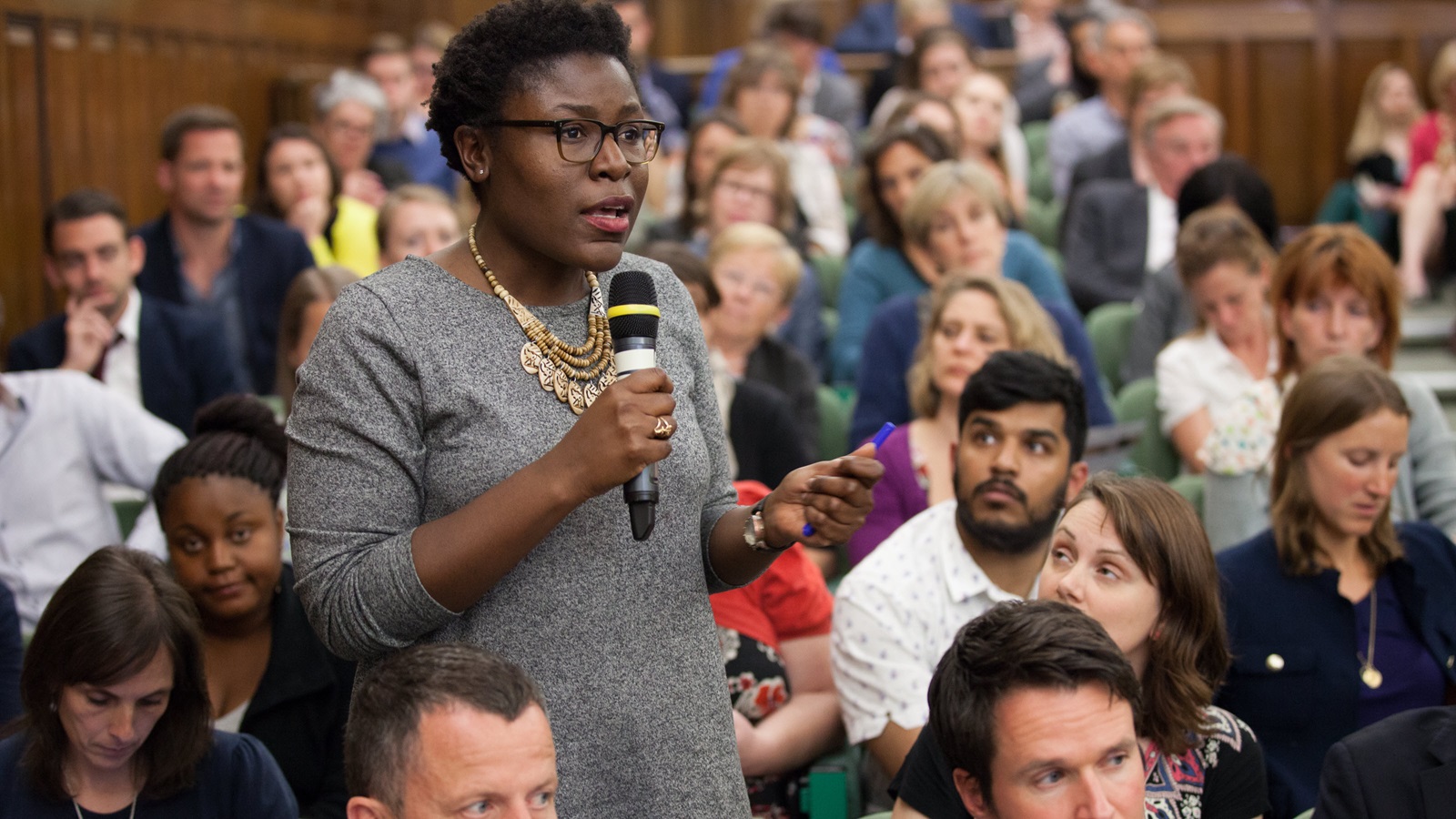 Member of the audience asks a question at the One Great George Street Conference Center during a discussion entitled: Family Planning - the rights of girls and women.