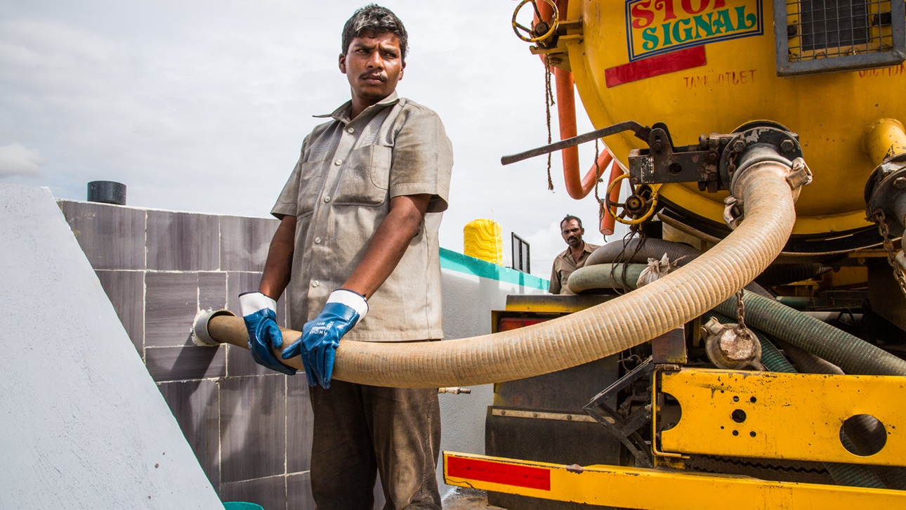 A tanker driver unloads waste at a fecal sludge treatment plant near Bangalore.