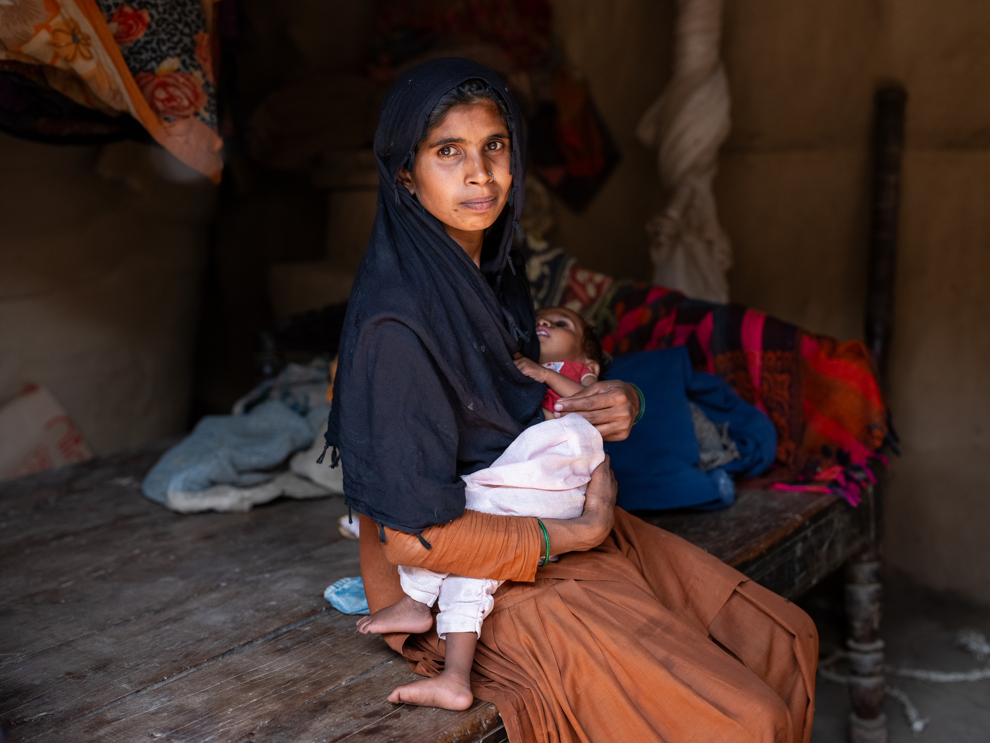 Portrait of Manna Pathani, mother of four, with her youngest daughter, Sumaiya Pathani, who is identified as a severely malnourished in Banke District, Narainapur Village, Nepal, on March 9, 2025.  