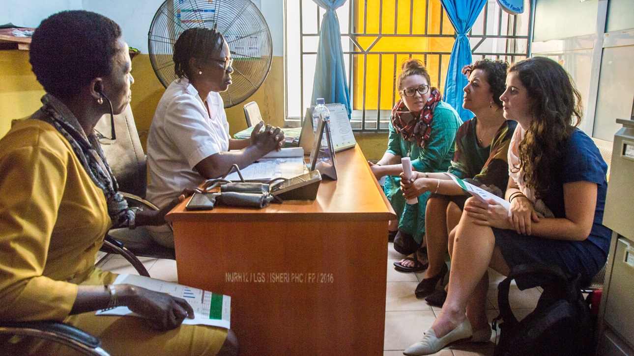 A nurse speaks with Ann Starrs, the foundation's director of Family Planning and foundation staff at a primary health center in Lagos, Nigeria.
