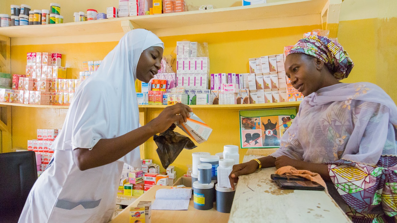 A pharmacist discusses medication with a customer at an urban public health center in Kaduna State, Nigeria