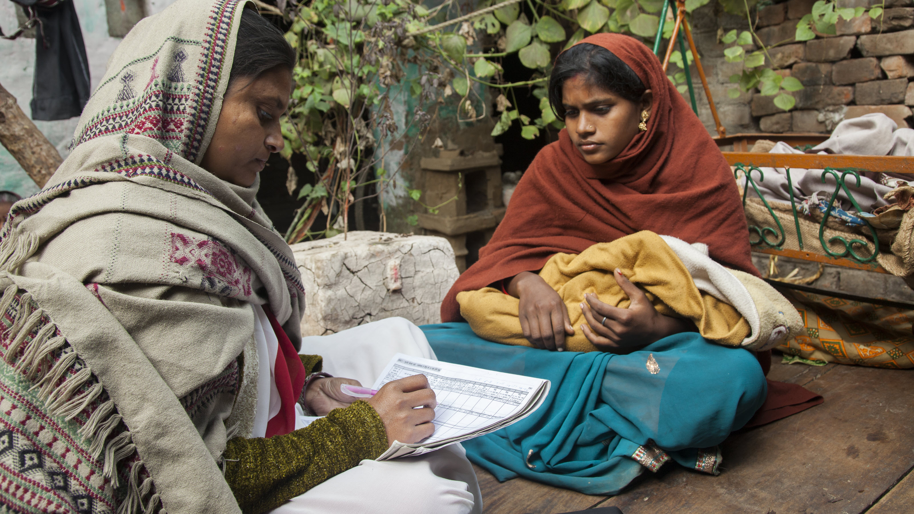 A home visit with a mother and newborn in the Patna district of Bihar, India.