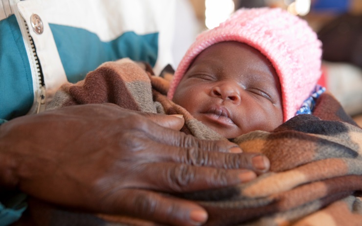 An Agogo (grandparent) checks on a mother and newborn baby in the Mzimba District, Malawi.