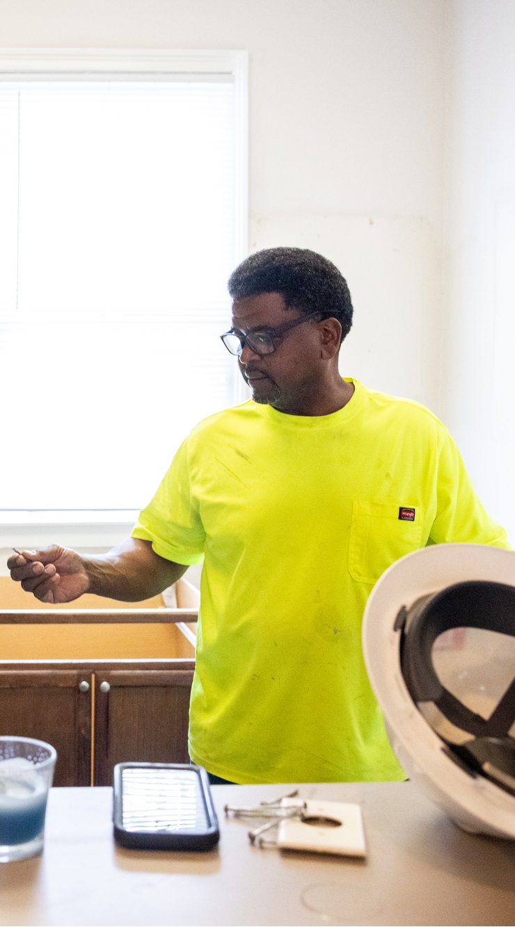 Intern Treyvon Moliere works with his mentor Shedrick Holden as part of a summer internship at Landis Construction in New Orleans, Louisiana, on July 25, 2023. Moliere was placed at this internship through YouthForce NOLA, a local non-profit preparing New Orleans public school students for competitive careers.