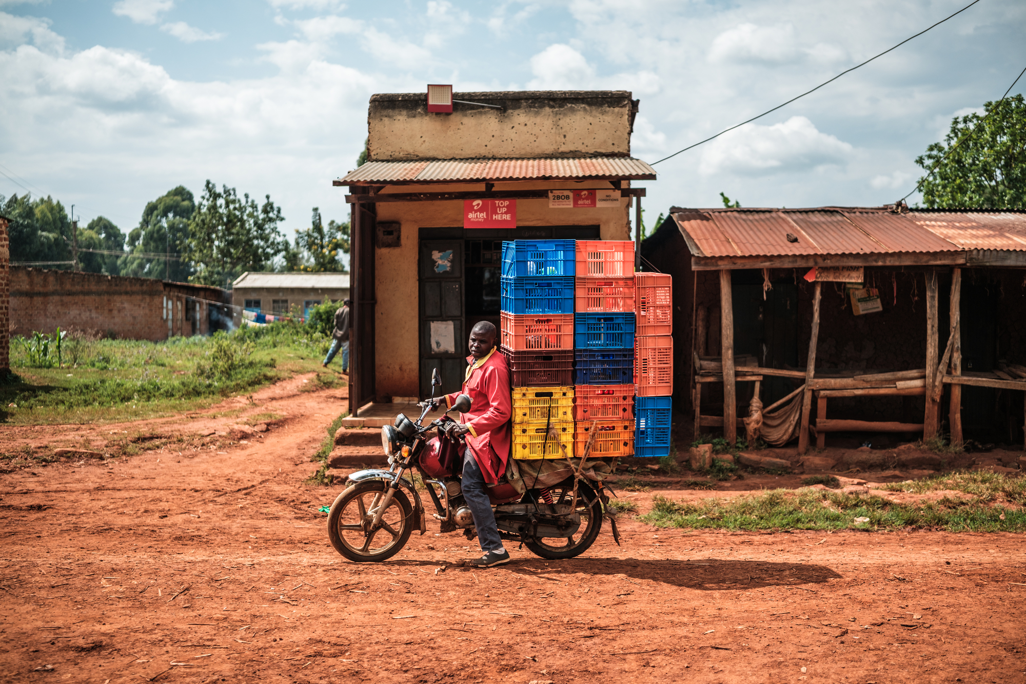 A motorcycle rider transports crates on his bike near Sinoko Subcounty Hospital.