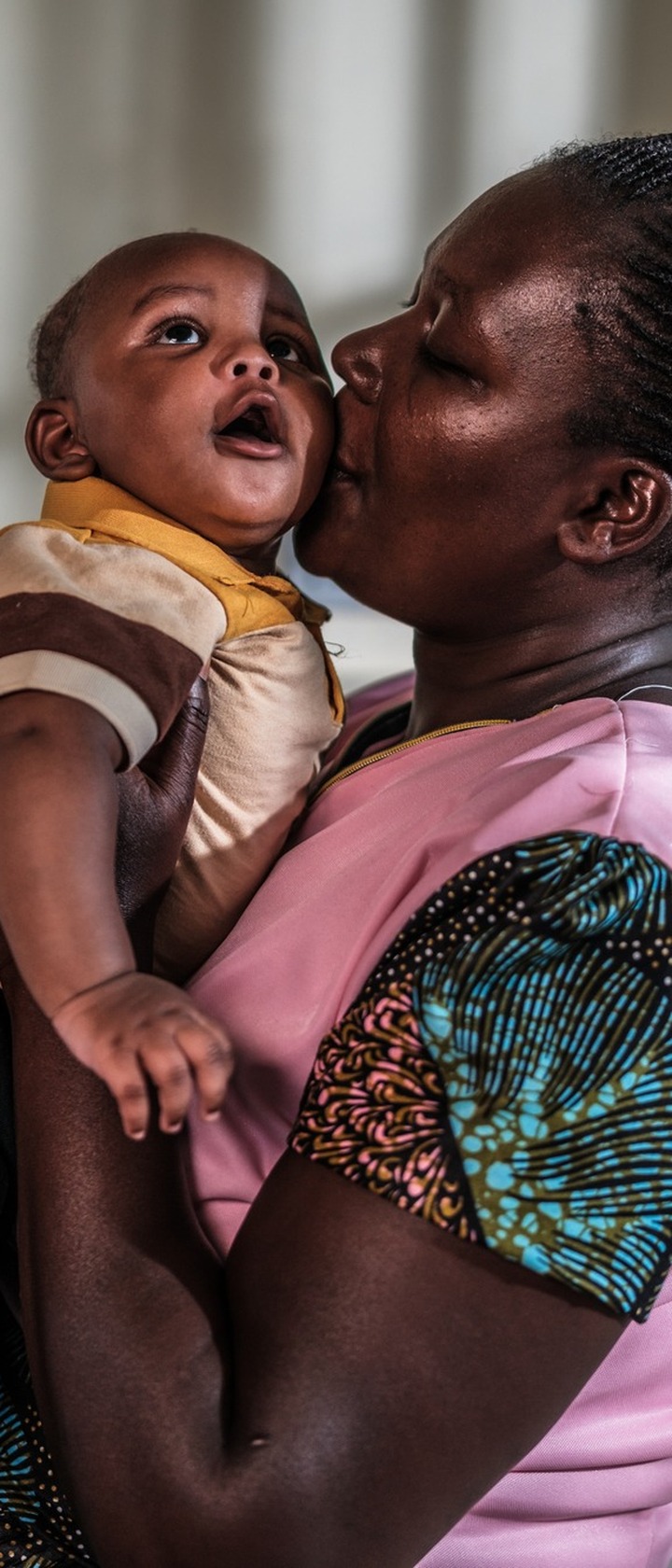 Hellen Marani and her child, Destiny David, at Sinoko Subcounty Hospital in Bungoma County, Kenya, where Marani comes for an ultrasound scan using a point-of-care ultrasound (POCUS) machine.