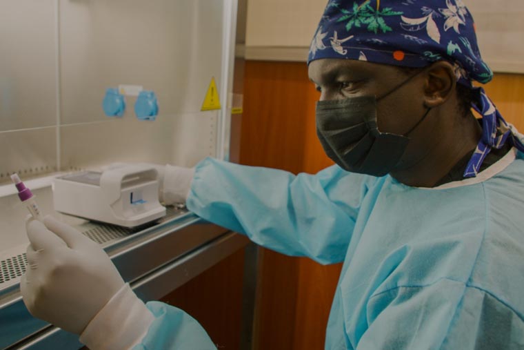 Dr. Onyimbo Kerama, Lead Consultant and Executive Director at Motire Occupational Health and Safety Solutions uses the LumiraDx diagnostic instrument to test for COVID-19 in Thika, Kenya. (August 28, 2021)