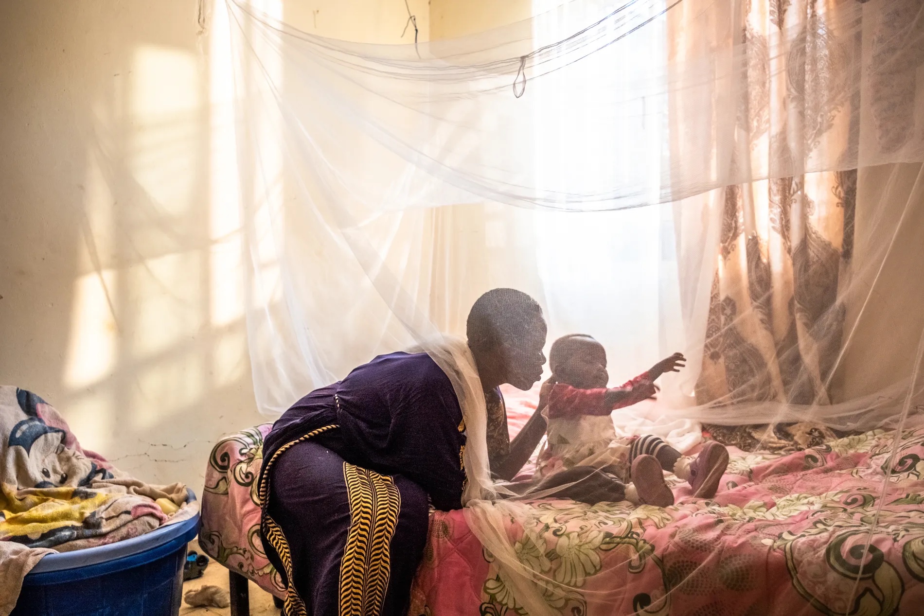 Trezer Aoko sits with her daughter, Precious Gift, at their home in Kisian, Kisumu County, Kenya County, Kenya.