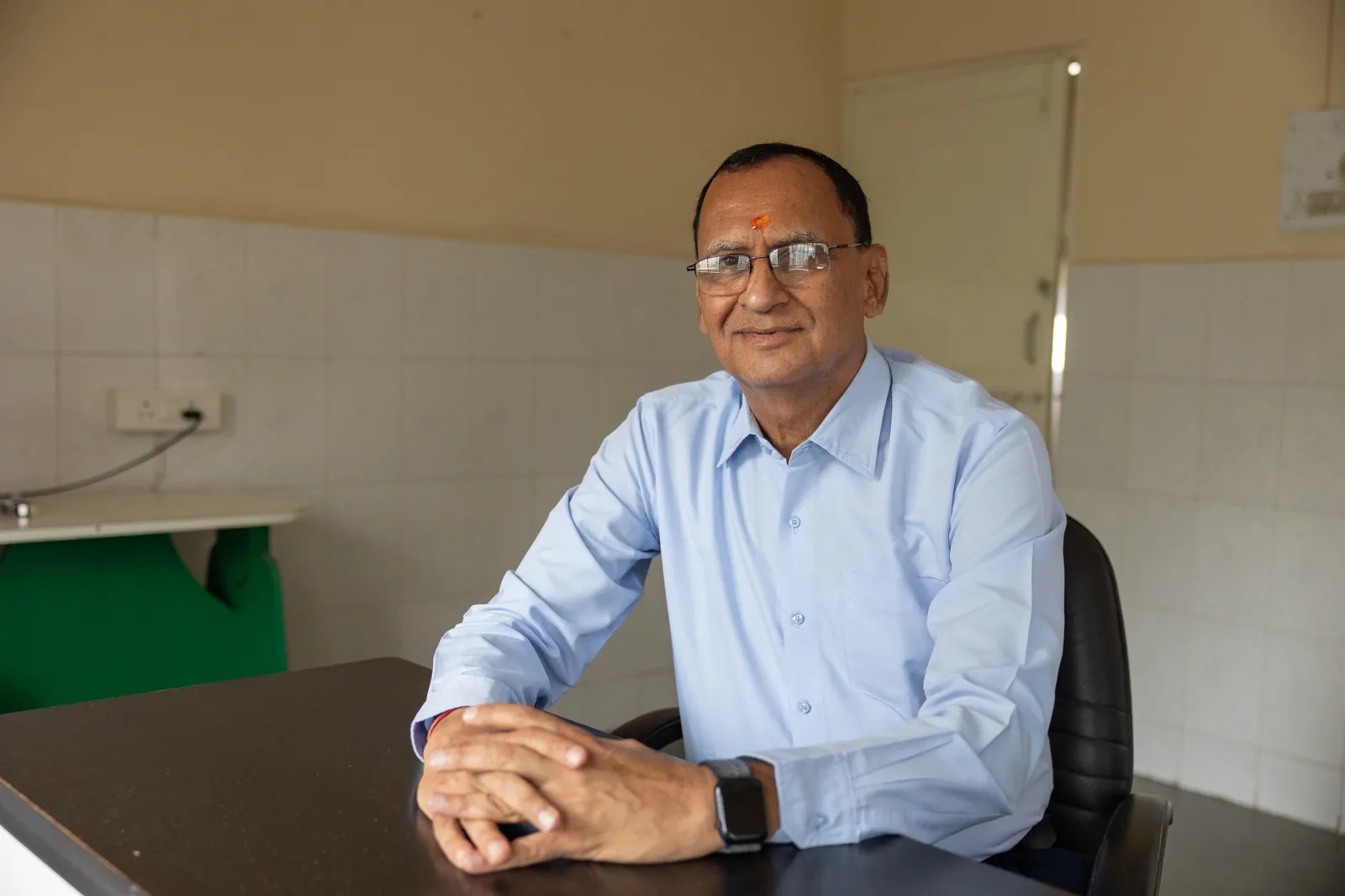 Dr. Naveen Thacker, Pediatrician, lifelong advocate against polio, and President of the International Paediatric Association, poses with the manuals created by him to create awareness on polio in Gandhidham, Gujarat, India.