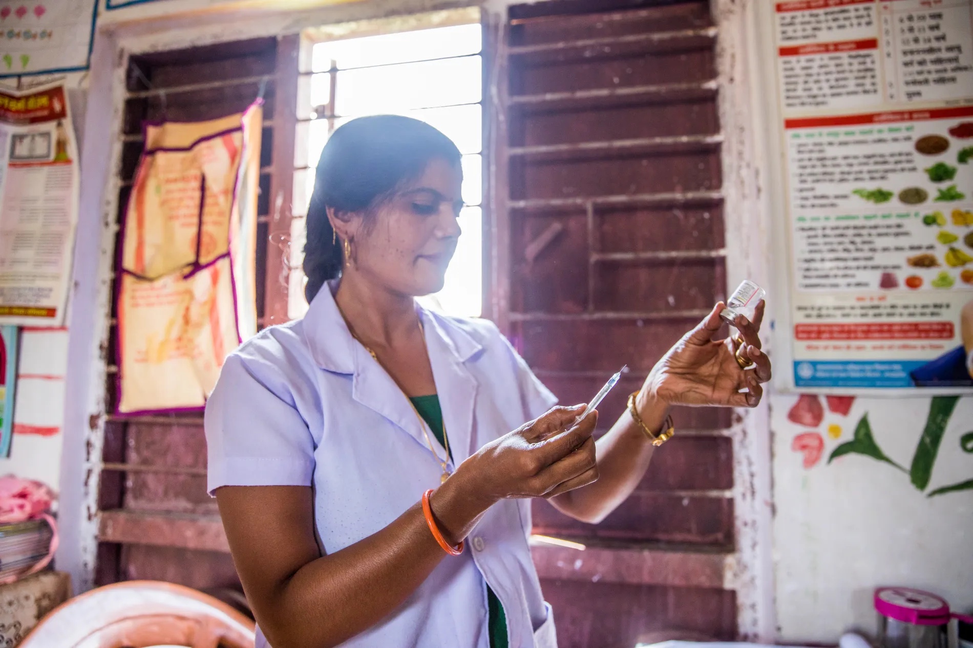 Gayatri Ahirwar, Auxiliary Nurse Midwife (ANM), prepares a vaccination at an Anganwadi Centre (AWC). Gayatri covers 14 such centres in the span of a month to provide care to pregnant women and newborn. She visits this particular centre once a month in Bhopal, Madhya Pradesh, India.